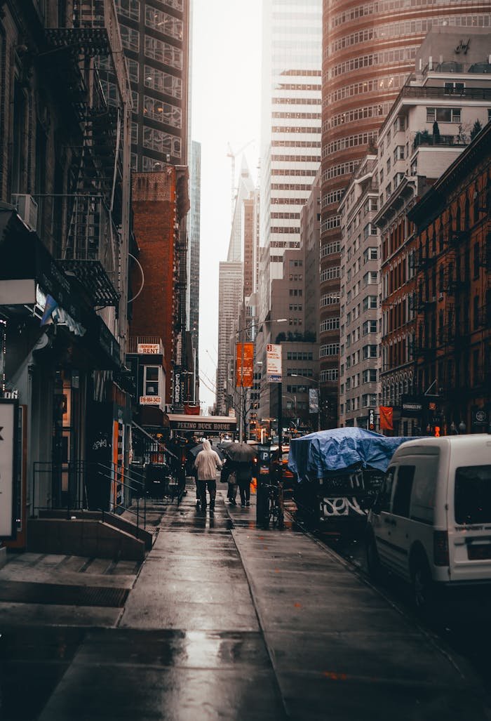 People Walking on Street Between Buildings